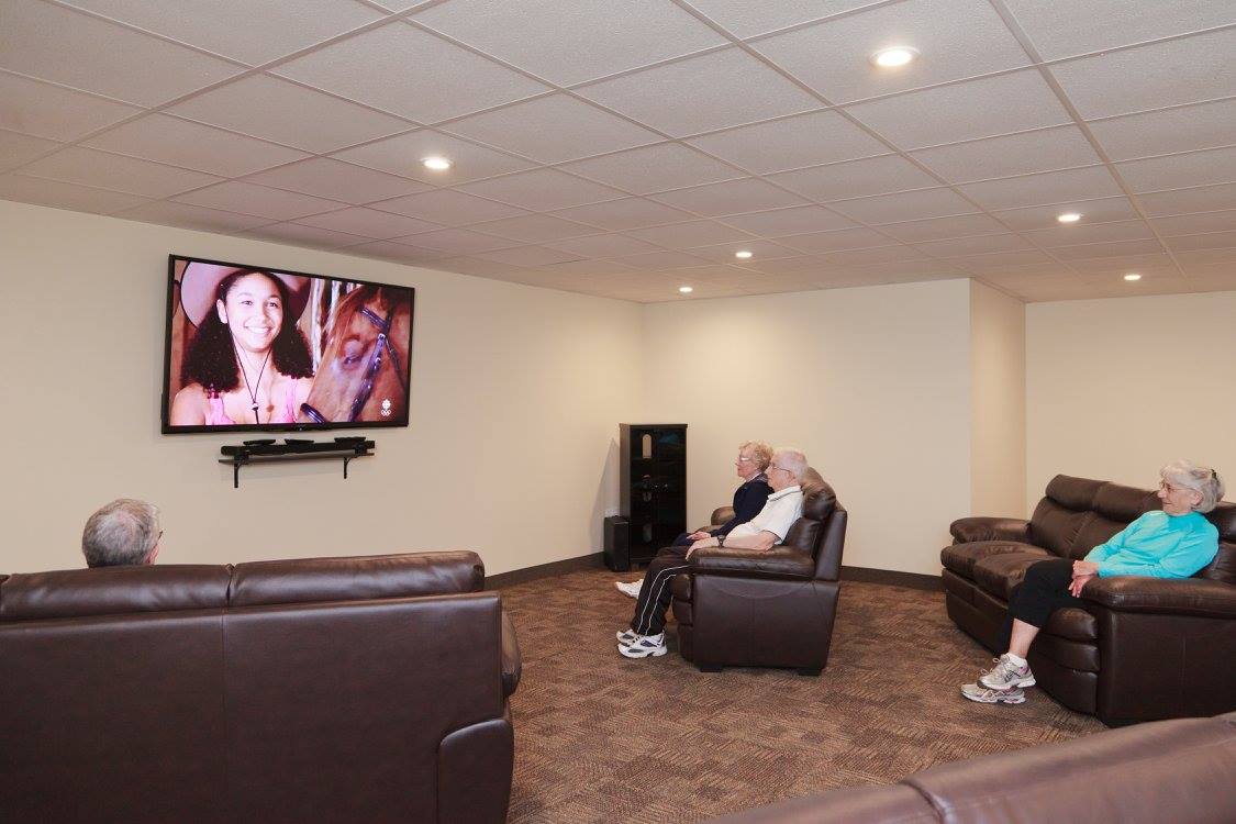 seniors watching a movie on a big screen